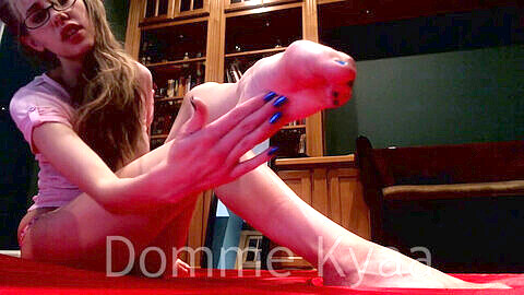 Blonde mistress Kyaa points her toes in cute pink socks and bare feet for foot worship kink