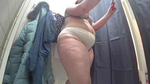 Spycam captures big-booty plumper trying on tight jeans and short dresses in a public fitting room