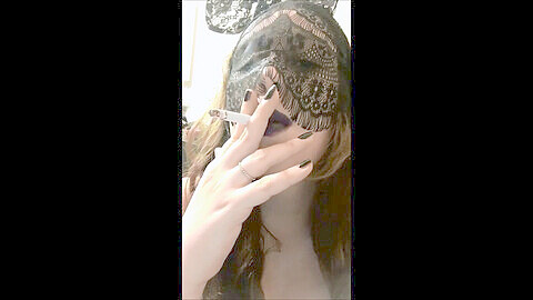 Smoking punk goddess with big natural tits wearing a black bunny mask and dark lipstick