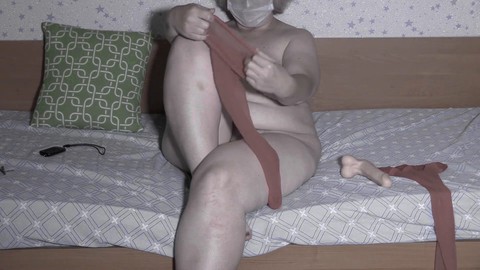 Plump mature MILF with a hairy pussy and massive drooping tits changes pantyhose