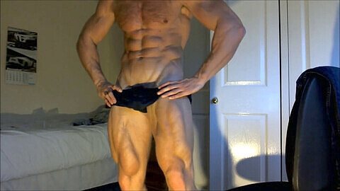 Adam Charlton flexes his bulging muscles, showing off his ripped body and pulsing veins in January 2012 gay muscle video.